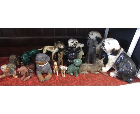 A collection of ceramic and other models of dogs including three large models of seated Old English Sheepdogs, a Sandicast mo