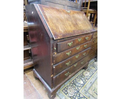 18th century walnut veneered bureau of four long drawers with crossbanded borders, raised on bracket supports, the fall flap 