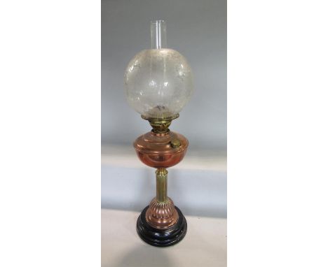 A brass and copper Corinthian column oil lamp, with stepped circular black marble plateau and etched shade, 57cm high in tota