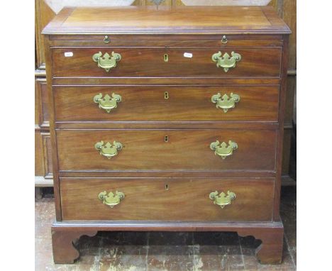 A small Georgian mahogany chest of four long graduated drawers, together with a brush slide, the top crossbanded with ebony s