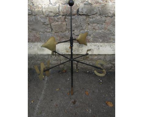 An ironwork weather vane with painted gilt highlighted metal letters and copper arrow head pointer beneath a raised ball fini