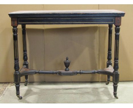 A late Victorian aesthetic movement period ebonised fold over top card table of rectangular form, with carved foliate detail 