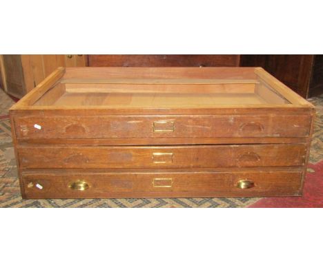 A vintage oak framed three drawer plan chest half section, (lacks top) 115 cm wide x 40 cm high (AF) 