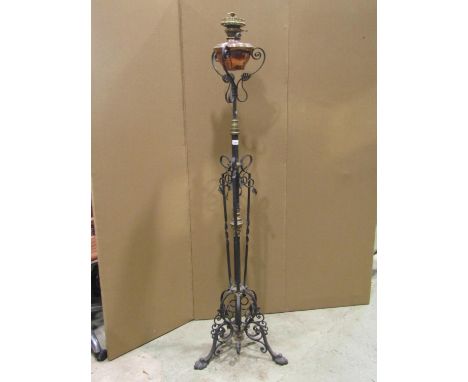 A late Victorian brass and iron work floorstanding telescopic oil lamp standard with decorative scrolling leaf, applied flowe