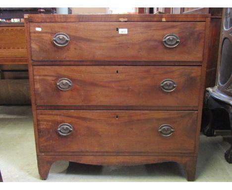 A Regency mahogany and pine sided caddy top bedroom chest of three long graduated drawers with oval brass foliate plate handl