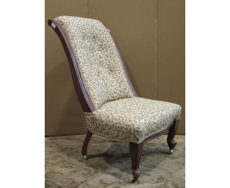 A Victorian mahogany nursing chair, with cream ground oak leaf and acorn pattern upholstered seat and combined shaped an scro