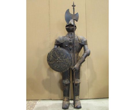 A floorstanding decorative scale replica of a suit of armour (knight) clutching a circular shield and long handled axe (sheet