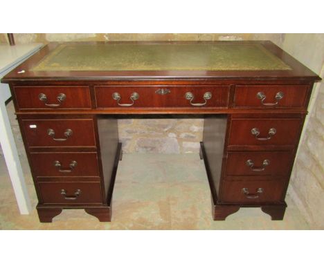 A reproduction Georgian style mahogany veneered kneehole twin pedestal desk, with inset green leather panelled top, over an a