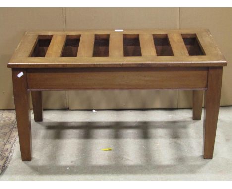 A vintage luggage stand of rectangular form with open slatted top and square tapered supports, 86 cm long x 46 cm wide 
