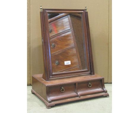 A Georgian mahogany toilet mirror of rectangular form with moulded frame and box base fitted with two frieze drawers raised o