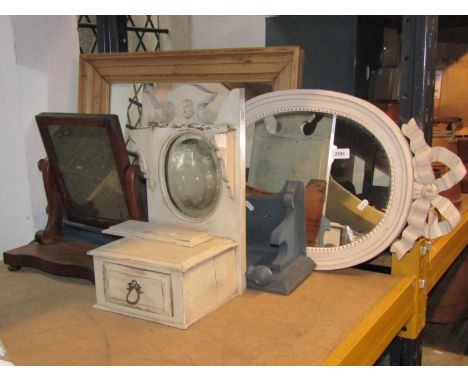 A small Victorian mahogany toilet mirror with shaped platform base together with an oval wall mirror with painted and moulded