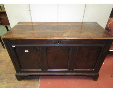 An 18th century, or earlier, coffer of simple construction with panelled framework, moulded stiles, bracket supports, monogra