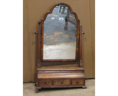 An antique Queen Anne style walnut veneered toilet mirror with moulded arched frame over an ogee box base fitted with three f