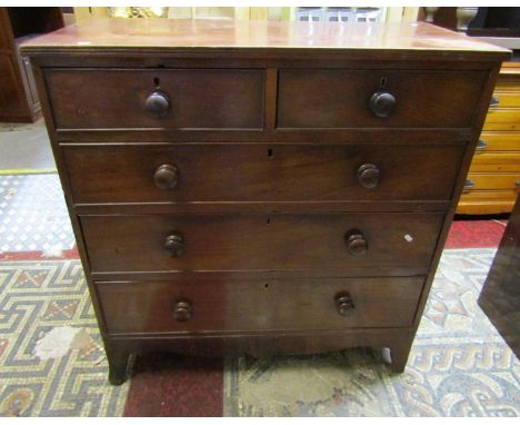 An early 19th century mahogany bedroom chest of two short over three long drawers with shaped apron and splay bracket support
