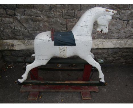 A vintage traditional rocking horse with trestle base and over painted finish (AF), 95 cm high 