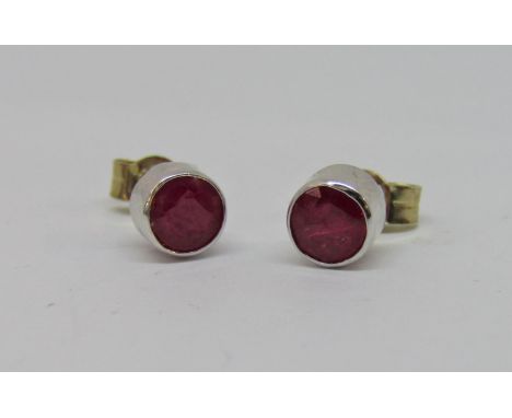 Pair of ruby stud earrings in unmarked white metal 