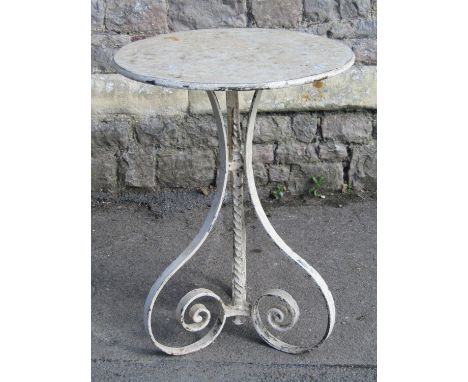 A small iron work garden/interior lamp table with circular top raised on scrolled supports united by a rope twist stem and al
