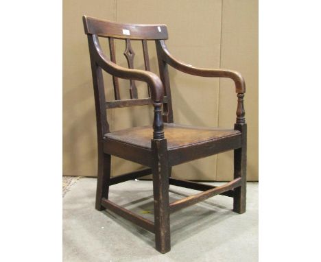 A 19th century country made bar and moulded stick back open elbow chair with central pierced splat, down swept arms, solid se