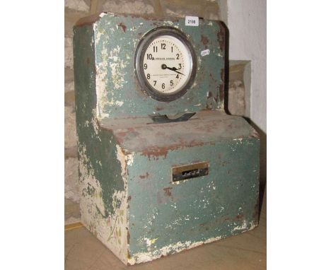 A vintage auto clock systems clocking in clock with circular dial 