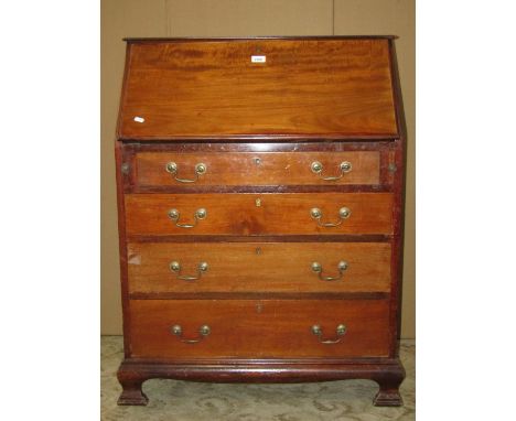 An Edwardian mahogany bureau in the Georgian style, the fall flap enclosing a simply fitted interior over four long graduated