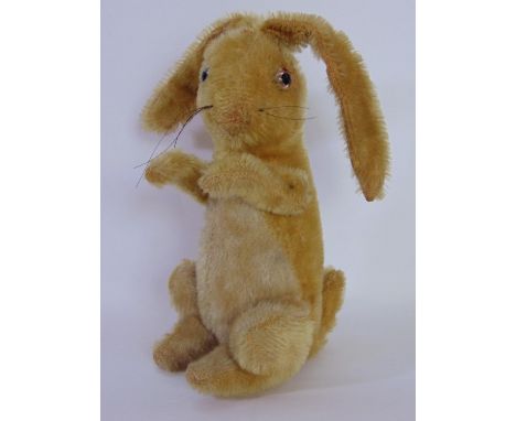Vintage rabbit, (possibly Steiff but no pin), with glass eyes, golden fur, whiskers, articulating front legs and long floppy 