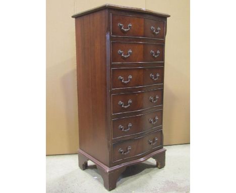 A small reproduction mahogany veneered chest in the Georgian style, the serpentine front fitted with six long drawers flanked