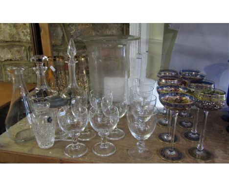 A large collection of glassware to include a storm lantern, decanters, various hand painted goblets and champagnes, etc 