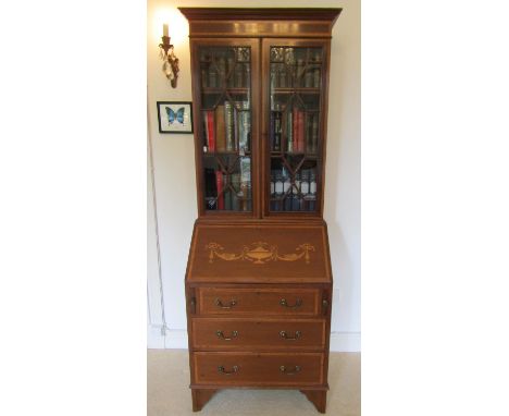 An inlaid Edwardian mahogany bureau bookcase with satinwood banding classical urn, tied ribbon and swag detail, the upper sec