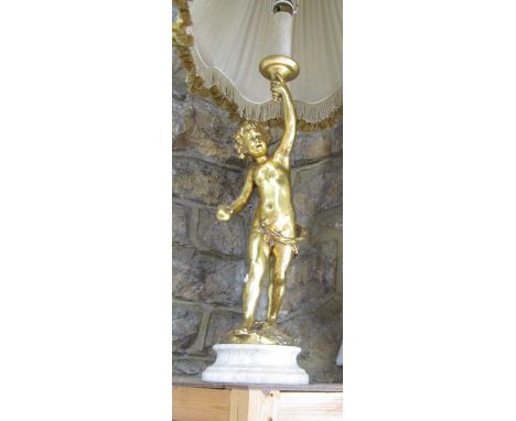 Figural table lamp in the form of a gilt wood type cherub holding a candle shaped sconce upon a stepped circular base, 83cm h