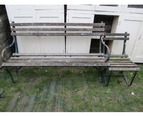 A three seat garden bench with weathered timber lathes and sprung steel supports, together with a similar two seat example an