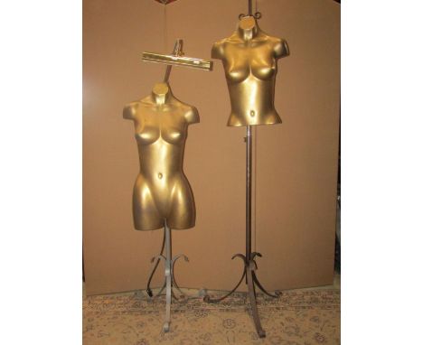 Two vintage moulded fibreglass female display torsos with gilt finish, raised on associated adjustable stands, one with artic