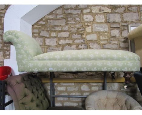 A Victorian chaise lounge/day bed with scrolled head rest, upholstered in light green ground repeating sprig patterned uphols