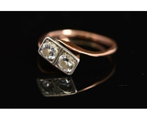 A MID 20TH CENTURY TWO STONE DIAMOND RING, each diamond grain set within a box setting, cross over design, estimated total ro