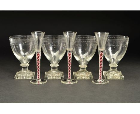 A SET OF FOUR EARLY 19TH CENTURY RUMMERS, the conical shaped bowls engraved with stars and borders of ovals, on short pedesta