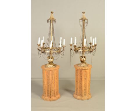 A PAIR OF 20TH CENTURY GILT METAL EIGHT LIGHT ELECTROLIERS, fitted with glass candles and mounted on carved pine decagonal pl