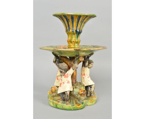 A LATE 19TH CENTURY JOSE A. CUNHA MAJOLICA CENTREPIECE, the trumpet shaped central vase above a circular tier moulded with th