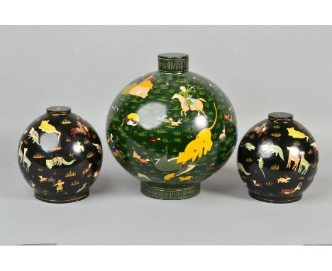 A PAIR OF 20TH CENTURY DECORATIVE PERSIAN LAMP BASES, the black painted spherical hollow wooden bases decorated with animals 
