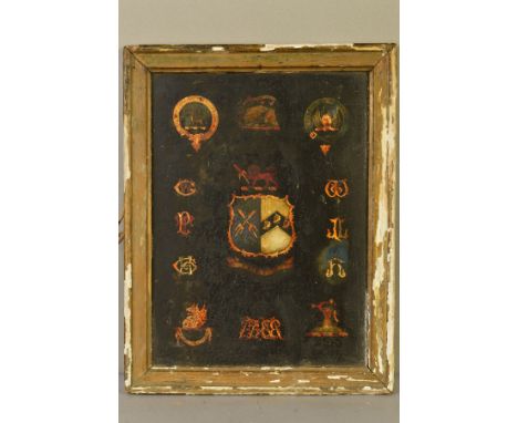 A LATE 18TH/EARLY 19TH CENTURY PAINTED PANEL, POSSIBLY FROM A CARRIAGE, bearing coats of arms, monograms and armorials, oil o