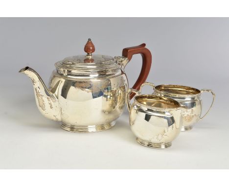 A GEORGE VI SILVER THREE PIECE TEA SERVICE, of oval form, brown bakelite handle and finial to the teapot, makers Roberts &amp