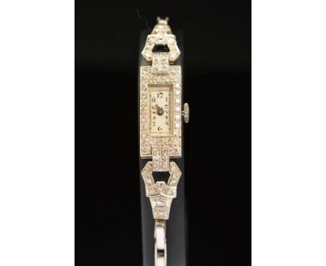 AN EARLY 20TH CENTURY DIAMOND COCKTAIL WATCH, rectangular shaped case, measuring 22mm x 10.1mm, estimated single cut diamond 