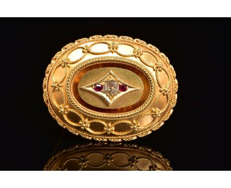 A LATE VICTORIAN GOLD, DIAMOND AND RUBY MEMORIAL BROOCH, of oval outline, the central old cut diamond flanked by rectangular 