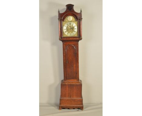 A GEORGE III OAK LONGCASE CLOCK, the arched hood with oval fretwork decoration and pointed finials, doric columns, brass 11''