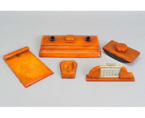 A GROUP OF FIVE ART DECO CARVACRAFT DESK ACCESSORIES IN BUTTERSCOTCH AMBER BAKELITE, comprising a rocker ink blotter, a perpe