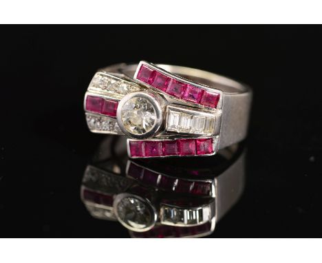 AN EARLY TO MID 20TH CENTURY RUBY AND DIAMOND COCKTAIL RING, centring on an early brilliant cut diamond, measuring approximat