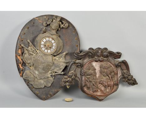 A 19TH CENTURY CONTINENTAL CARVED OAK WALL PLAQUE, with female mask above cartouche carved with two herdsmen, dog and cattle,