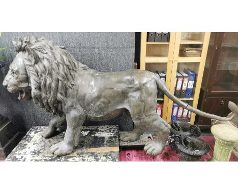 An impressive large life size bronze sculpture of a lion, overall L. 235cm H. 122cm. T TO PRICE.