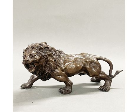 A bronze sculpture of a lion, L. 33cm H. 15cm.