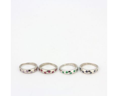 Four 925 silver stone set rings including emerald, amethyst, ruby and sapphire, (K).