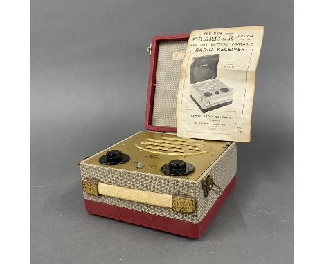 A vintage portable 'The petite' radio with original instruction leaflet.