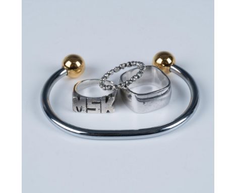 Wonderful collection of jewelry that includes a double bell bangle, a geometric square ring size 8, a signet ring marked with